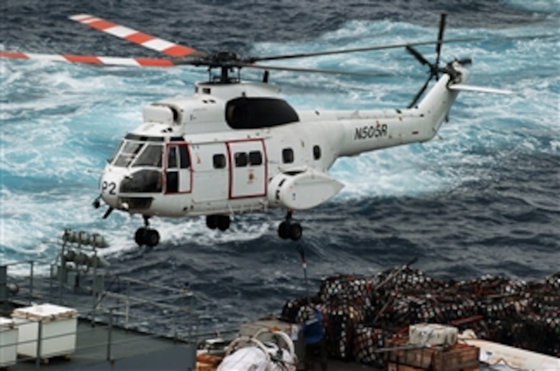 An AS-332 Super Puma helicopter transports supplies from the Military Sealift Command combat stores ship USNS Concord to the nuclear-powered aircraft carrier USS Nimitz, April 1, 2008. Nimitz is deployed to the U.S. 7th Fleet operating in the western Pacific and Indian oceans. 