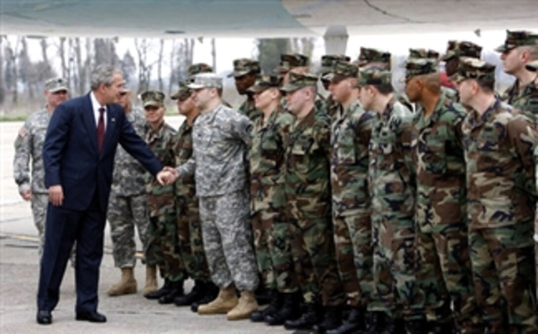 President George W. Bush reaches out to U.S. military personnel  April 2, 2008, as he arrived at Mihail Kogalniceanu Airport in Constanta, Romania, for his return flight to Bucharest after meeting with President Traian Basescu at his presidential retreat in Neptun. 