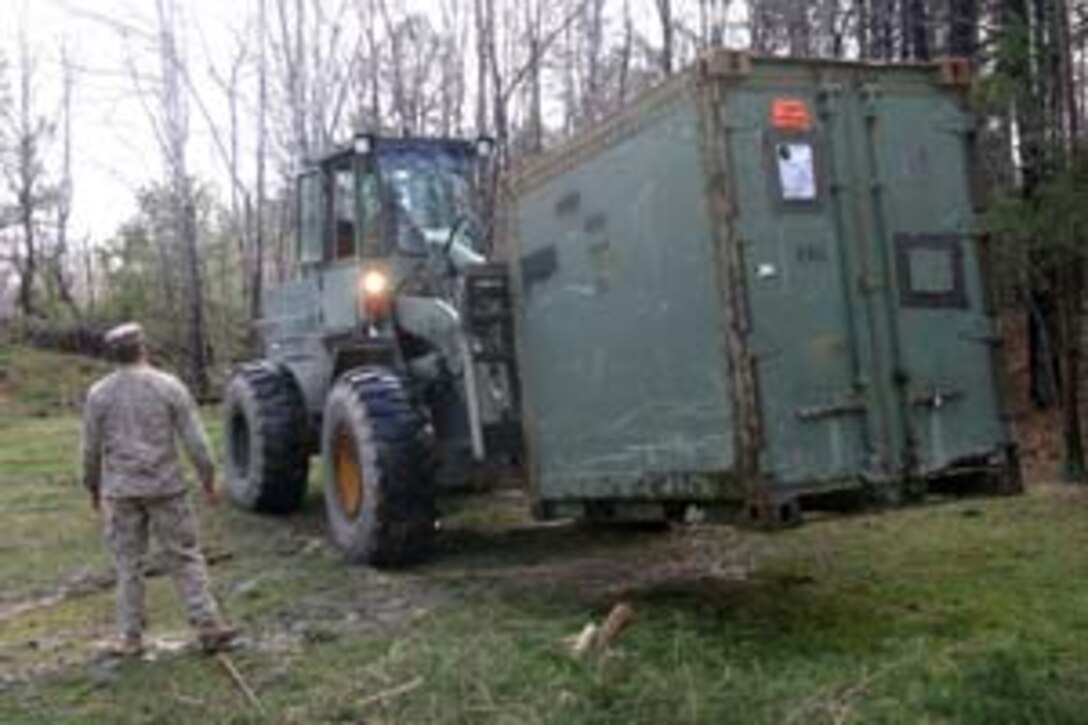 Their work finished, the Marines of Combat Logistics Battalion 26 pack up their tools to go. The Marines built a new pistol rangehouse for the Blackstone Police Department in Blackstone, Va., from March 31 to April 4, 2008. Marines from CLB-26, the combat logistics element of the 26th Marine Expeditionary Unit, endured cold and rain for the project, which helped the Blackstone community and sharpened their own skills. The 26th MEU is conducting unit training here to prepare its Marines and sailors for a planned deployment later this year.