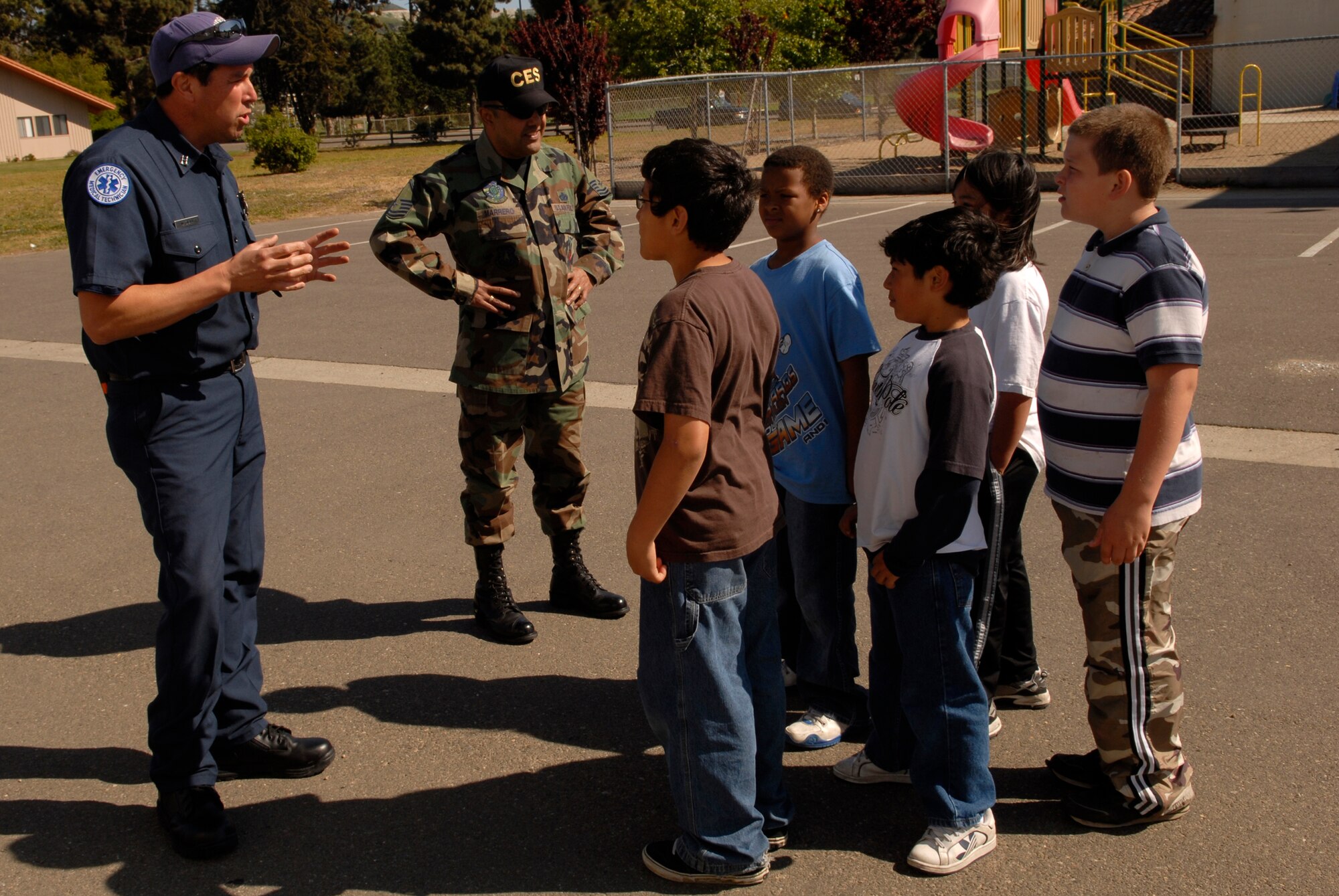 LOMPOC, Calif. -- Marty Silva and Master Sgt. Clemente Marrero, fire fighters with the 30th Civil Engineer Squadron, Vandenberg Air Force Base, Calif., teach children at the Lompoc Boys and Girls Club the characteristics of fire and smoke on April 3. The VAFB fire department is involved with the local community to educate citizens to be more conscience of fire hazards and the importance of having a household fire safety plan. (U.S. Air Force photo/Airman 1st Class Christian Thomas) 
