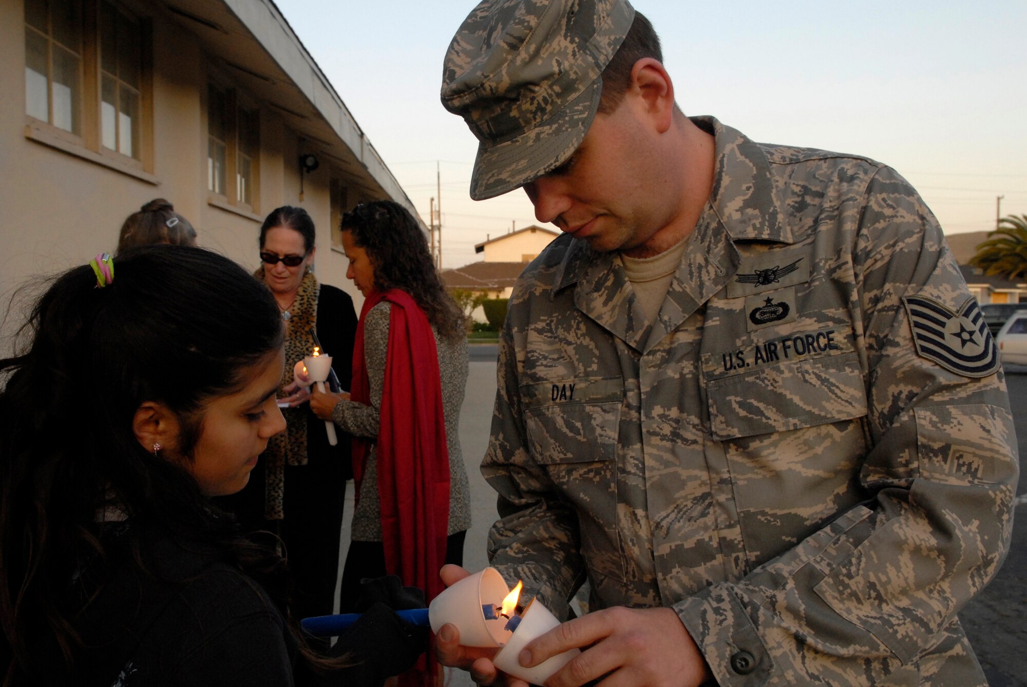 LOMPOC, Calif. -- Tech. Sgt. David Day, a intelligence analyst with the 614th Air and Space Operations Center in Vandenberg Air Force Base, Calif., lights a candle for Linda Ruiz during the 11th annual North County Rape Crisis and Child Protection Center candlelight vigil on April 1. The vigil is to honor the survivors of sexual assault and to prevent future assaults through awareness. The North County Rape Crisis and Child Protection Center was established in 1974 and has been providing care to Vandenberg ever since. (U.S. Air Force photo/Airman 1st Class Christian Thomas) 