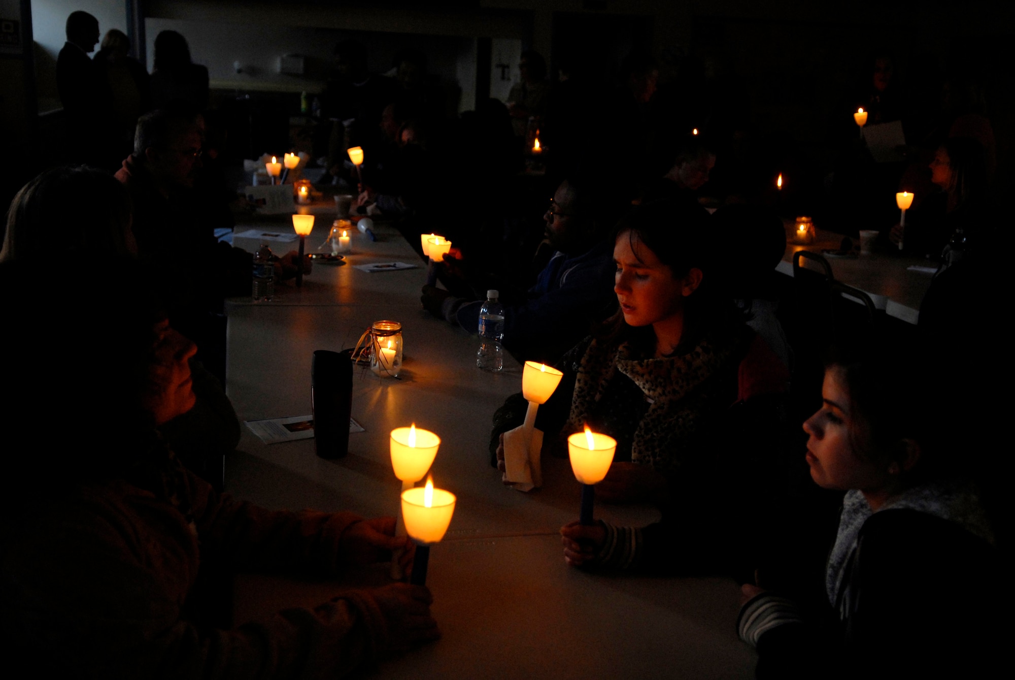 LOMPOC, Calif. -- Airmen and civilian volunteers take a moment of silence to remember sexual assault survivors during the 11th annual North County Rape Crisis and Child Protection Center candlelight vigil on April 1. The vigil is to honor the survivors of sexual assault and to prevent future assaults through awareness. The North County Rape Crisis and Child Protection Center was established in 1974 and has been providing care to Vandenberg ever since. (U.S. Air Force photo/Airman 1st Class Christian Thomas) 
