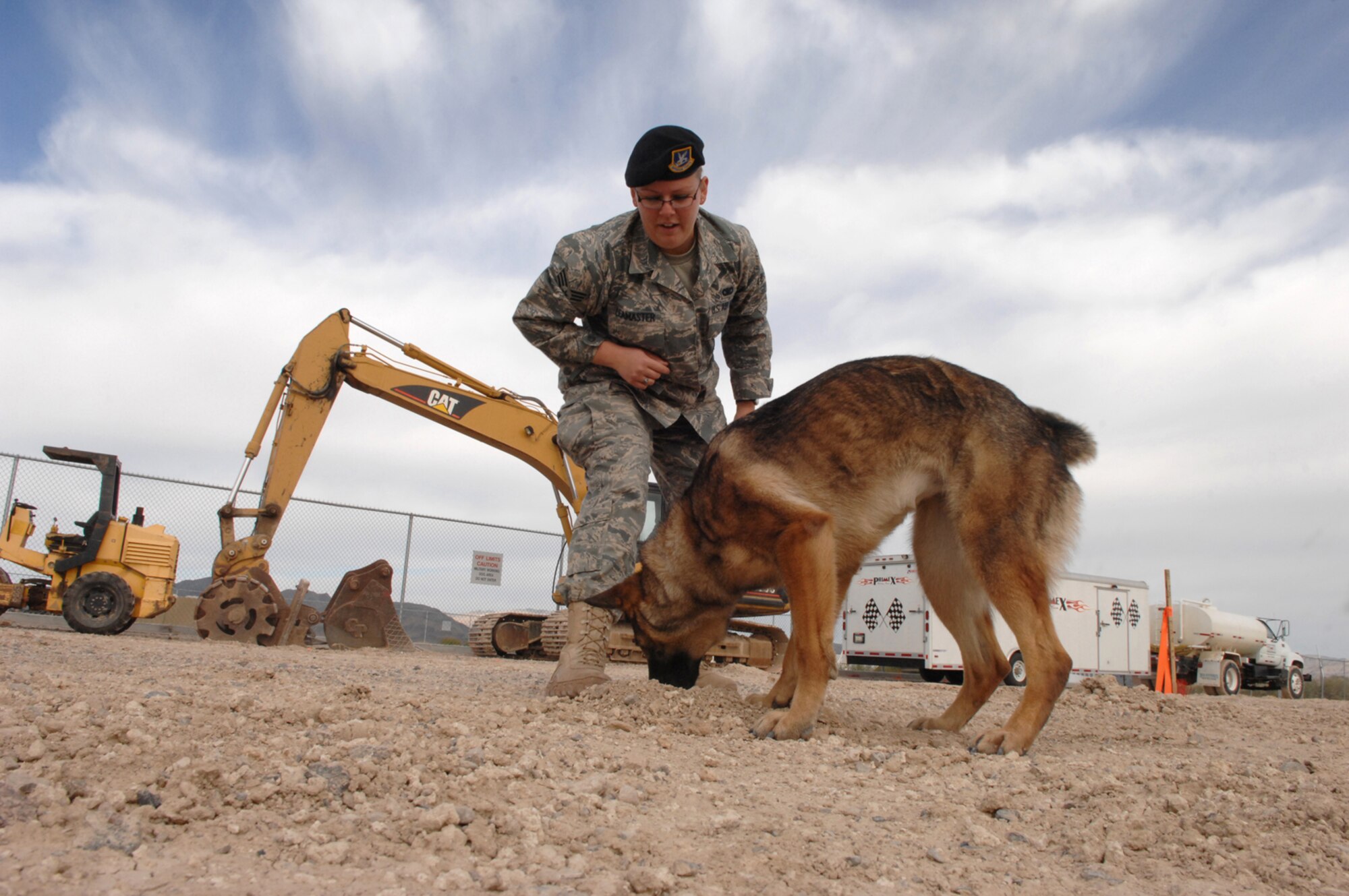 NELLIS AIR FORCE BASE, Nev. -- Senior Airman Amber Leamaster, a military working dog handler with the 99th Security Forces Squadron here, watches as her working dog Elza locates a foreign object at the 99th Security Forces Ground Combat Training Squadrons Military Working Dog compound March 28 Creech AFB, Nev. The 99th GCTS MWD element is currently building a new 1.47 million dollar, 4,300 square foot kennel facility to house 14 military working dogs. Once completed, the facility will become the second largest in the Air Force and will train 150 to 175 working dogs and handlers for deployment per year.
(U.S. Air Force Photo by Senior Airman Larry E. Reid Jr.)
