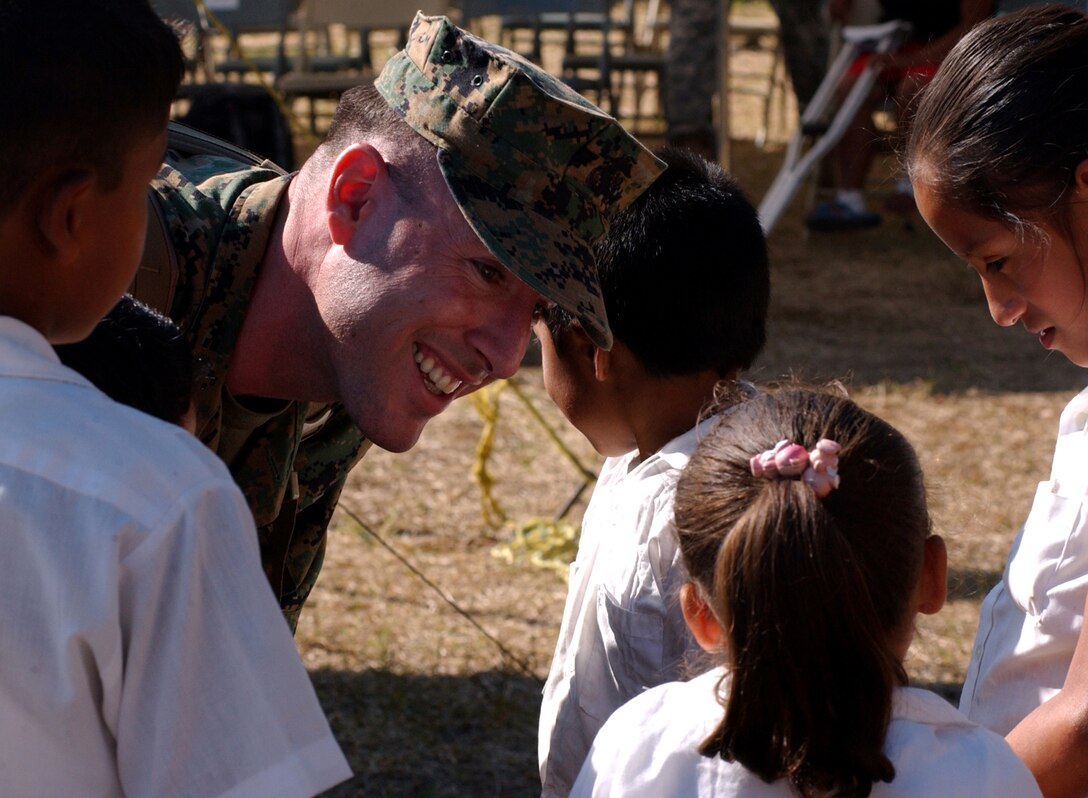 Sgt. Keith S. Day of the 3rd Civil Affairs Group from Camp Pendleton, Calif., speaks with some of the children of Florida de Marcala before the opening ceremony for Beyond the Horizon, a combined effort between the U.S. and Honduran militaries to provide medical services to Honduran citizens and complete construction projects in several towns across the country through June.