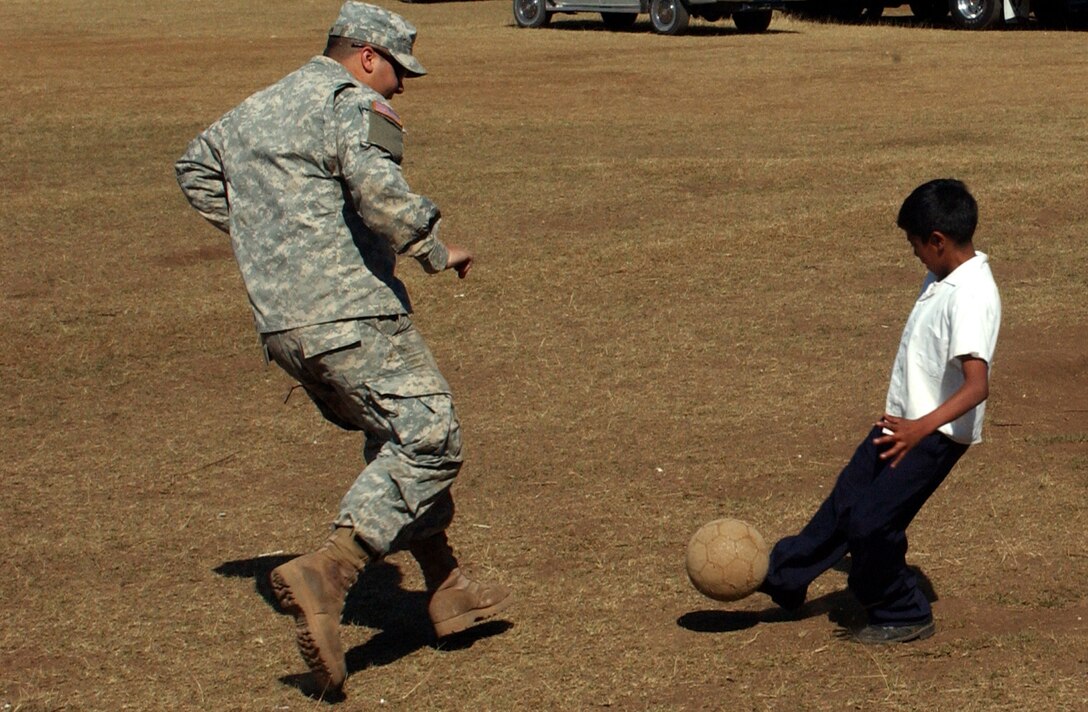 Pvt. Jacob E. Green of the 872nd Maintenance Company from Ogden, Utah, has some fun with a local boy in Florida de Marcala during the Beyond the Horizon opening festivities.  BTH is a joint endeavor between the U.S. and Honduran militaries to provide medical services to Honduran citizens and complete construction projects.
