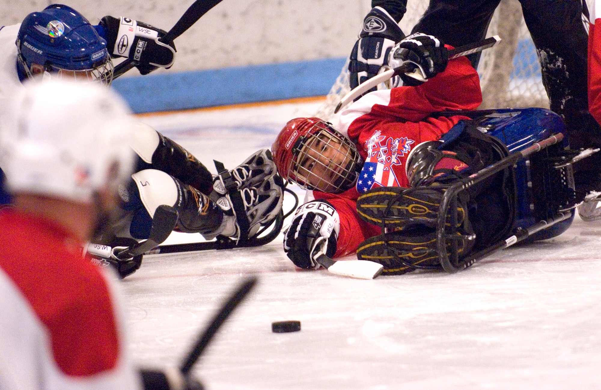 Disabled Marine Corp veteran, Gregory Rodriguez, stops a puck against the blue team at a sled hockey game during the 22nd National Disabled Veterans Winter Sports Clinic held at the Snowmass Village, Colo., April 2. The annual disabled learn-to-ski clinic helps motivate and rehabilitate disabled Department of Defense veterans. It is the largest of its kind in the world. The clinic instructs veterans on Alpine and Nordic skiing, rock climbing, snowmobiling, sled hockey, and more. (U.S. Air Force photo/Tech. Sgt. Cecilio Ricardo)
