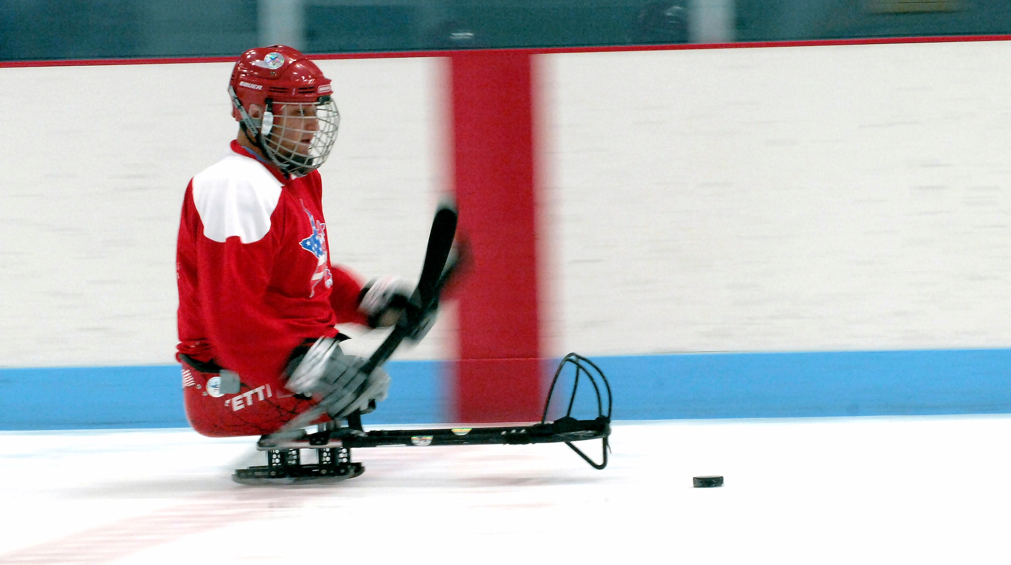 Disabled Army veteran, Shane Parsons handles a puck at a sled hockey game during the 22nd National Disabled Veterans Winter Sports Clinic held at the Snowmass Village, Colo., April 2. The annual disabled learn-to-ski clinic helps motivate and rehabilitate disabled Department of Defense veterans. It is the largest of its kind in the world. The clinic instructs veterans on Alpine and Nordic skiing, rock climbing, snowmobiling, sled hockey, and more. (U.S. Air Force photo/Tech. Sgt. Cecilio Ricardo)
