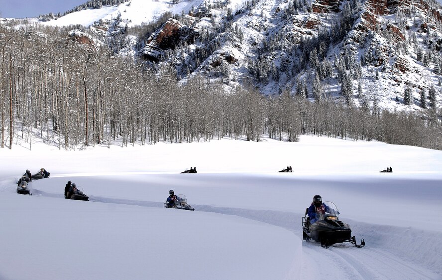 Several disabled veterans snowmobile under careful supervision during the 22nd National Disabled Veterans Winter Sports Clinic held at the Snowmass Village, Colo., April 2. The annual disabled learn-to-ski clinic helps motivate and rehabilitate disabled Department of Defense veterans. It is the largest of its kind in the world. The clinic instructs veterans on Alpine and Nordic skiing, rock climbing, snowmobiling, sled hockey, and more. (U.S. Air Force photo/Tech. Sgt. Cecilio Ricardo)