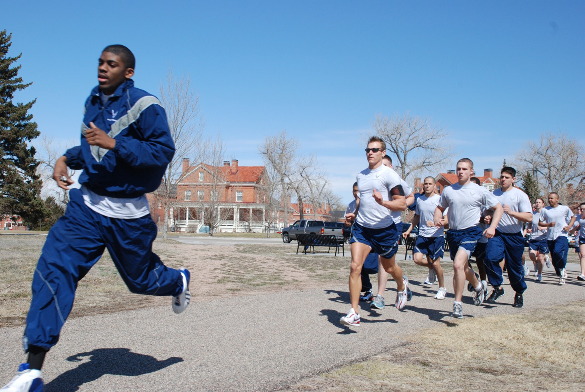 Airman Julius Philpot, 90th Security Support Squadron, leads his classmates in a timed run around the Argonne Parade Field here April 2. Airman Philpot is a member of a physical training leader program (U.S. Air Force photo/Airman 1st Class Daryl Knee).
