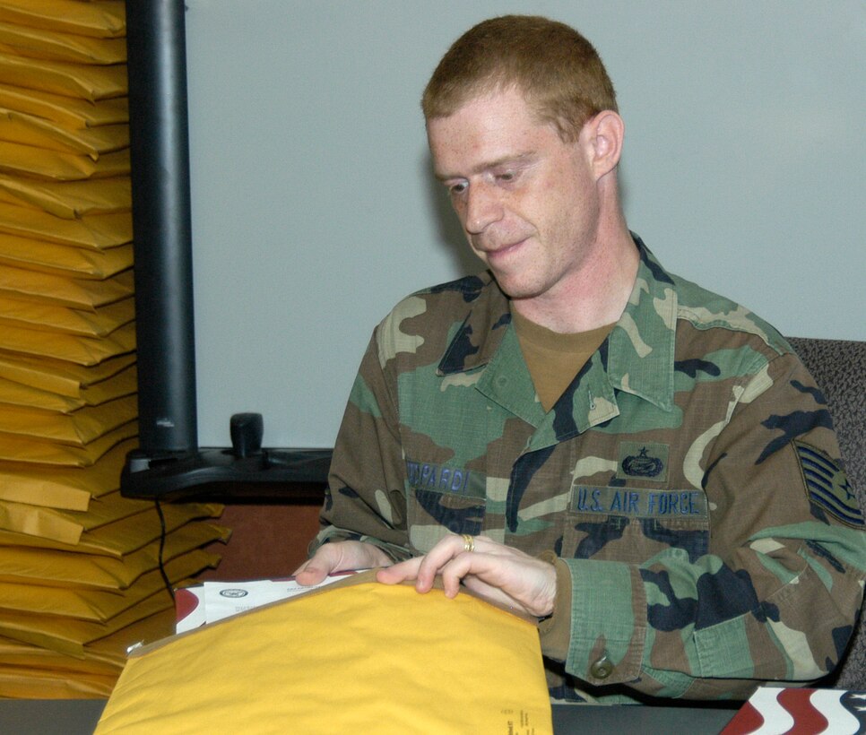 Tech. Sgt. Steven Azzopardi, DPS, packages a U.S. flag at the Air Reserve Personnel Center in Denver, Colo. The flags are sent to retiring reservists who request one through ARPC's online retirement application. (U.S. Air Force photo/Mike Molina)