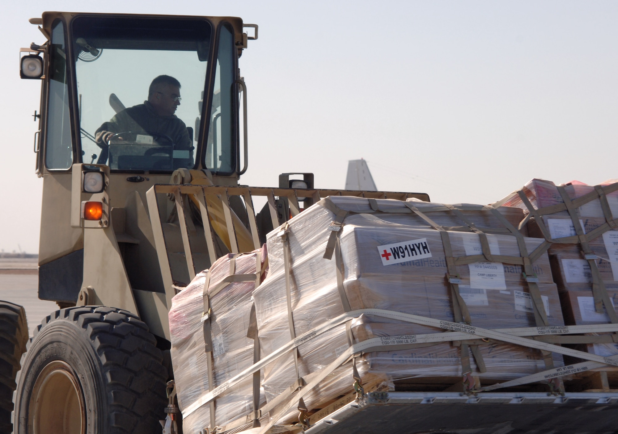 Master Sgt. Rogue Fuentes loads cargo onto a C-130 Hercules aircraft Balad Air Base, Iraq.  Sergeant Fuentes, an aerial port flight ramp service technician with the 332nd Expeditionary Logistics Readiness Squadron, is a reservist deployed from the 74th Aerial Port Squadron at Lackland Air Force Base, Texas. (U.S. Air Force photo/Master Sgt. Heather Cabral)