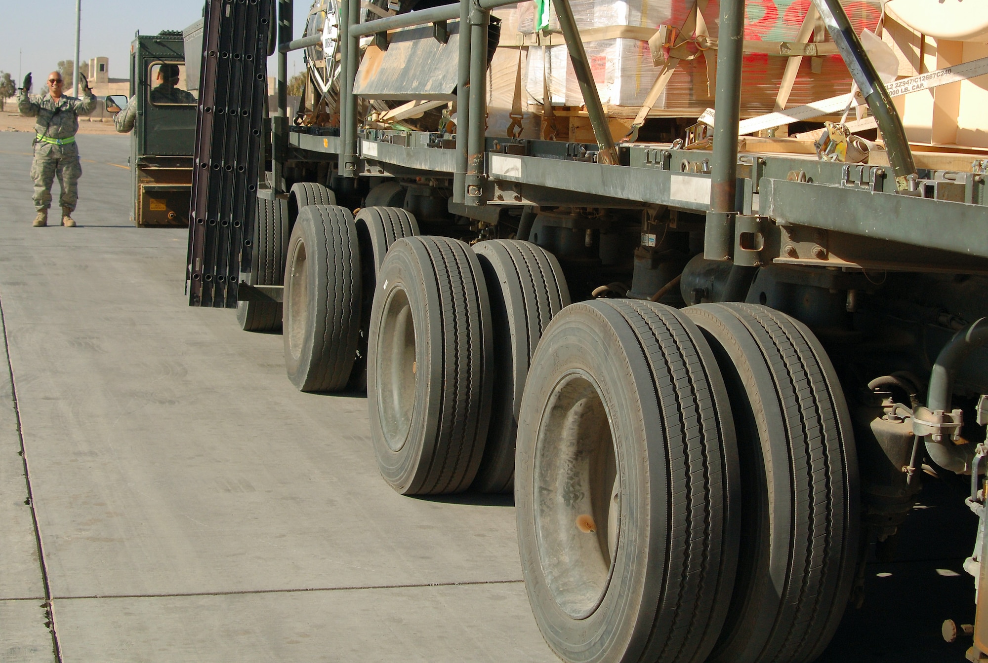Tech. Sgt. Peter Aguilar spots a 60K Tunner loader as it leaves the cargo yard at Balad Air Base, Iraq.  Sergeant Aguilar, an aerial port flight ramp service technician with the 332nd Expeditionary Logistics Readiness Squadron, is a reservist deployed from the 88th Aerial Port Squadron at McGuire Air Force Base, N.J.  (U.S. Air Force photo/Master Sgt. Heather Cabral)