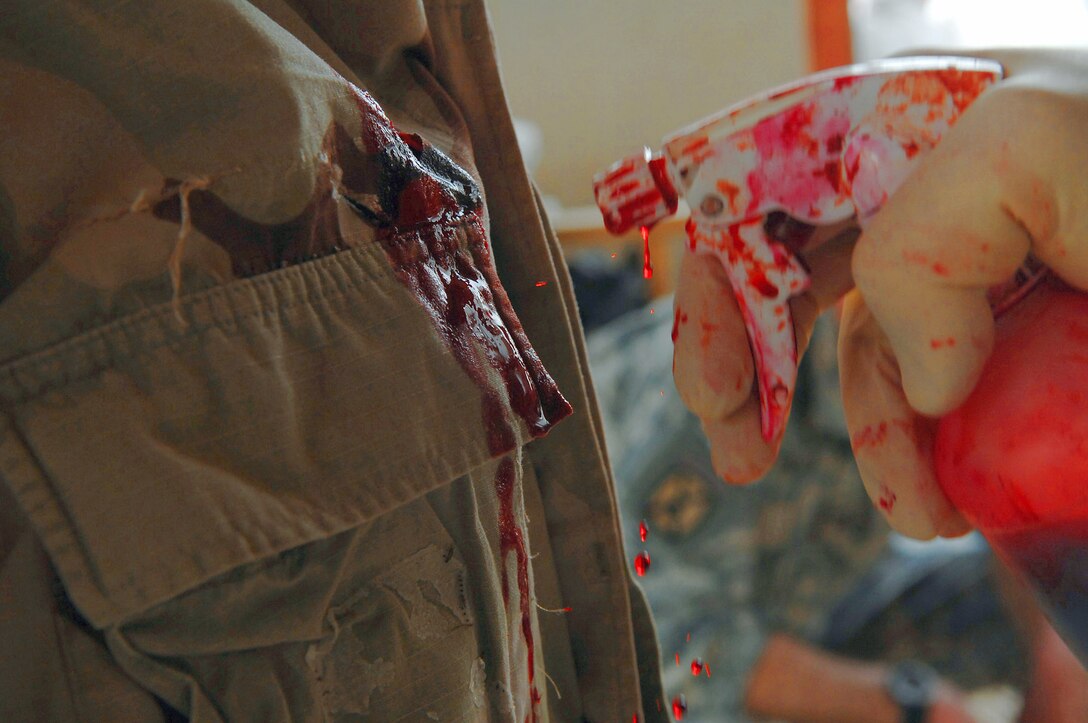 Moulage is added to give an element of realism during a mass casualty battle drill March 31 at Balad Air Base, Iraq. Fake blood, burns, lacerations and many other types of wounds were used to make the different scenarios come to life. (U.S. Air Force photo/Senior Airman Senior Airman Julianne Showalter) 