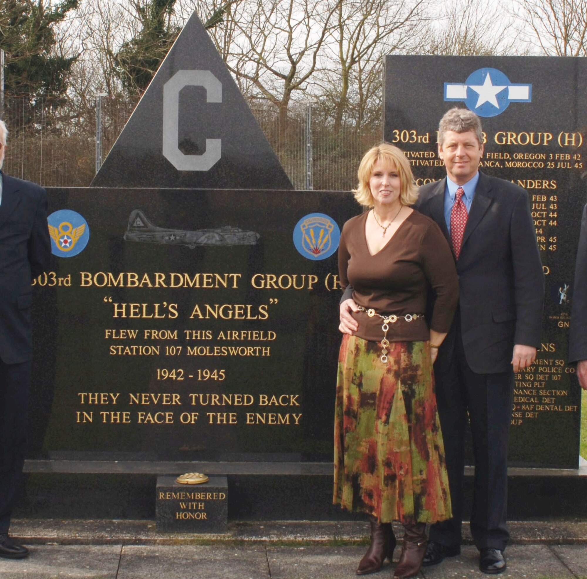 Ms. Suzanne Wilson stands with her partner, Mr. Colin Poole at the memorial to the 303rd Bomb Group at Royal Air Force, Molesworth, England.  Ms. Wilson was at the base to participate in a ceremony at which records of the airmen who served here during WWII assembled by her father, B17 pilot Edgar Miller were presented to the JAC.  (U. S. Air Force photo by Staff Sgt Chad E. Chisholm)