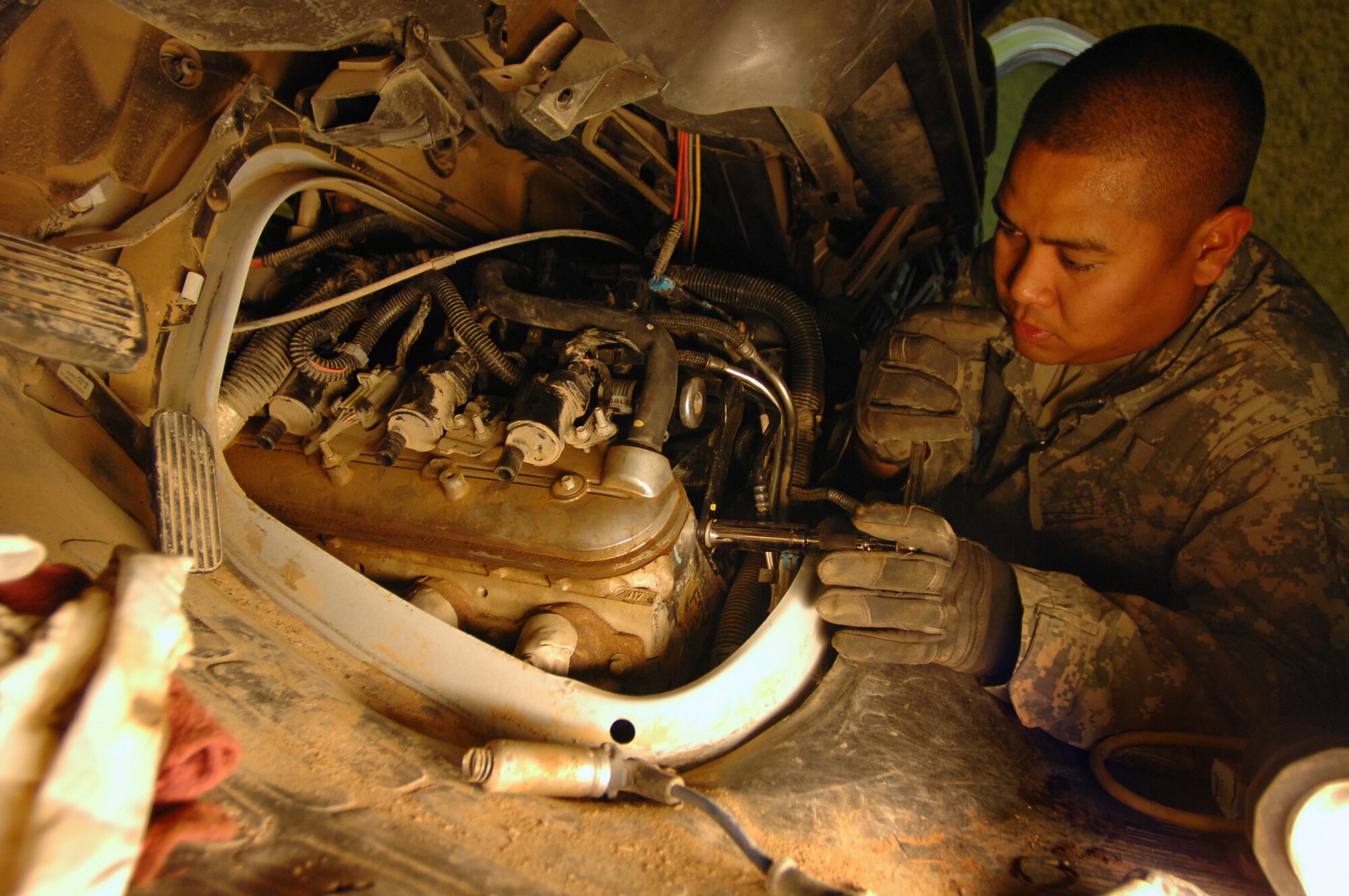 BALAD AIR BASE, Iraq -- Staff Sgt. Daniel Miranda, 332nd Expeditionary Logistics Readiness Squadron vehicle mechanic, replaces a cracked air intake manifold here, April 2. Maintenance on general-purpose vehicles is the bulk of the mechanics work. The 332 LRS also provides a wide range of expeditionary combat support capabilities necessary to protect, enable and sustain combat operations for the 332nd Air Expeditionary Wing and its tenant units. Sergeant Miranda is deployed from Nellis Air Force Base, Nev. (U.S. Air Force photo/ Senior Airman Julianne Showalter)