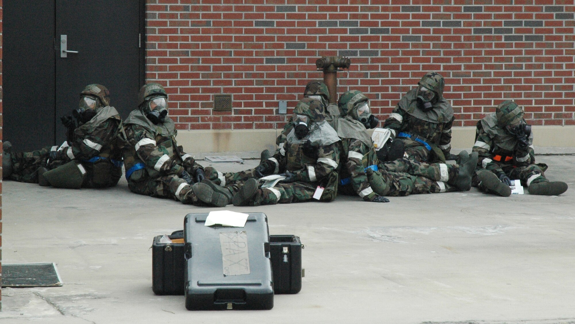 Members of the 315th Airlift Wing, Charleston Air Force Base, S.C., gather outside after a simulated building attack evacuation during the wing's mobility exercise.  The exercise was in preparation for the unit's Operational Readiness Inspection. (photo by Captain Bryan Lewis, USAFR)