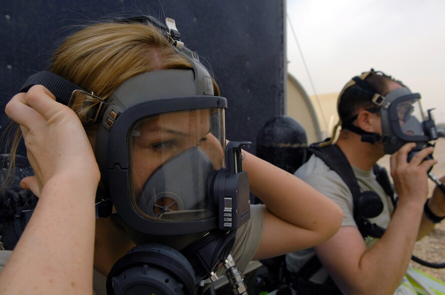Senior Airman Krista McVicar tightens her oxygen mask during an emergency management drill March 26 at Balad Air Base, Iraq. Emergency management Airmen conduct battle drills to keep skills sharp. Airman McVicar is with the 332nd Expeditionary Civil Engineer Squadron. (U.S. Air Force photo/Senior Airman Julianne Showalter)