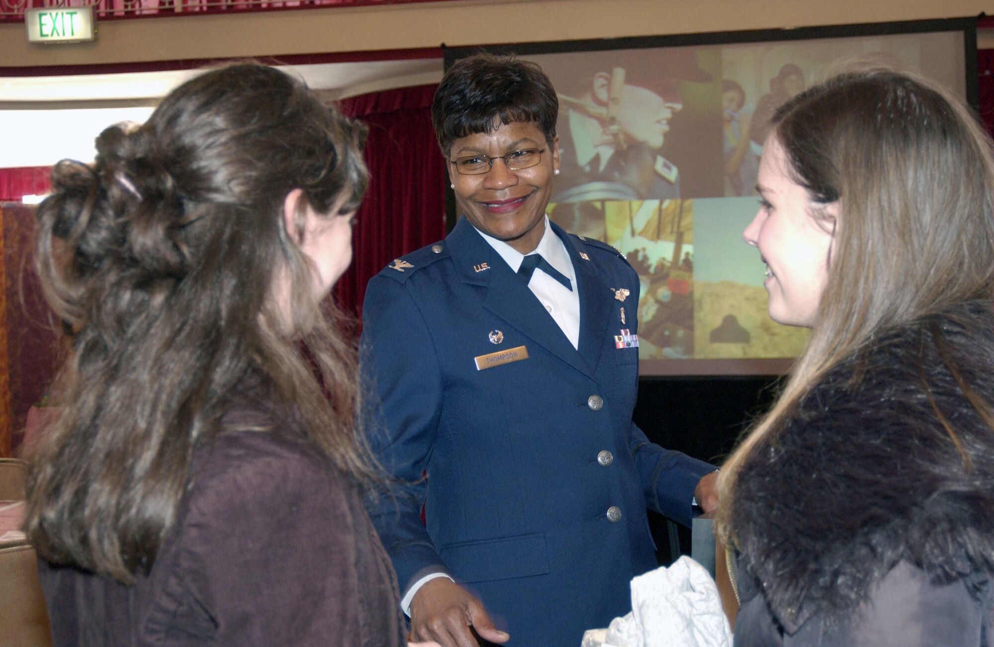 Col. Angela Thompson, 435th Medical Group commander and guest speaker, talks with two Kaiserslautern Middle School seventh graders after the U.S. Army Garrison Kaiserslautern's 2008 Women's History Month observance March 28 at the Armstrong Community Club on Vogelweh Housing. Photo by Christine June