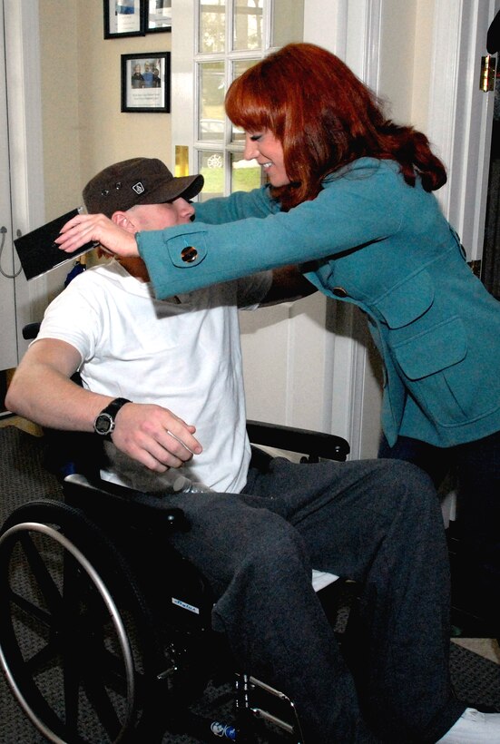 U. S. Army Cpl. Joseph McCauley gets a hug from comedienne Kathy Griffin during her April 3, 2008, visit to  Walter Reed Army Medical Center. McCauley, recovering from a traumatic brain injury he sustained March 23, 2008, while serving in Iraq, is a patient at the hospital. 
