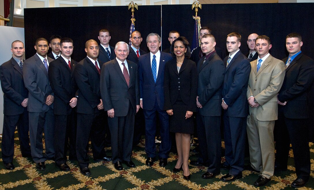 President George W. Bush (center) with Defense Secretary Robert M. Gates and Secretary of State Condoleezza Rice pose with U.S. Marines from the Embassy in Romania during the Bucharest NATO Summit held there, April. 4, 2008.  