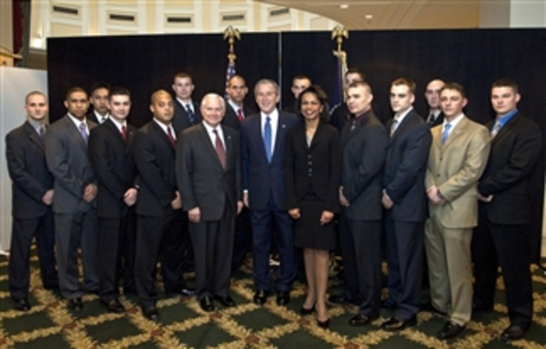 President George W. Bush (center) with Defense Secretary Robert M. Gates and Secretary of State Condoleezza Rice pose with U.S. Marines from the embassy in Romania during the Bucharest NATO Summit held there, April 4, 2008.  