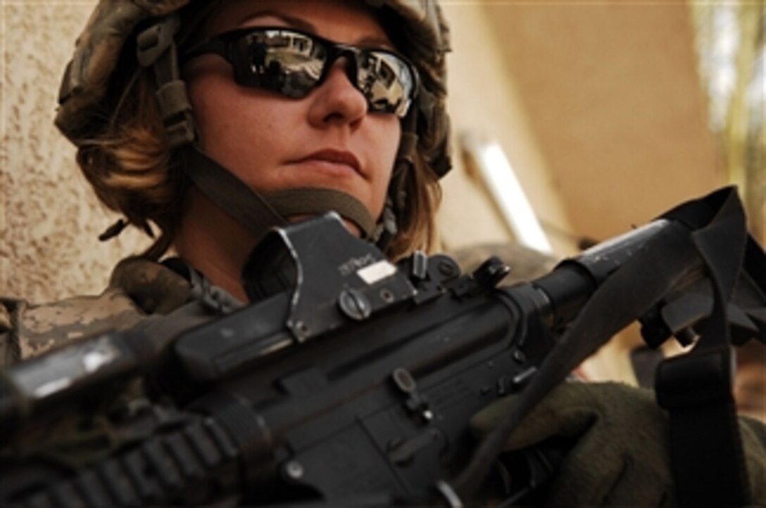 U.S. Army Spc. Rebecca Buck watches the street as she provides perimeter security outside an Iraqi police station in the Tarmiya Province of Iraq, on March 30, 2008.  Buck is an Army medic from Headquarters and Headquarters Company, 1st Battalion, 14th Infantry Regiment, 2nd Stryker Brigade Combat Team, 25th Infantry Division.  