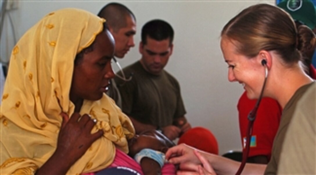 Lt. Sara Nelson, U.S. Navy, examines a child during a medical civic action program in Damerjog, Djibouti, on April 2, 2008.  Navy and Marine Corps medical teams from the USS Tarawa Expeditionary Strike Group joined with Army soldiers from the 354th Civil Affairs Brigade to kick off the six-day project.  