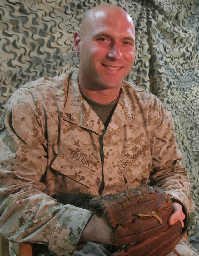 Lance Cpl. Scott "Ski" Halisky, a mortuary affairs specialist with Personnel Retrieval and Processing Detachment, Headquarters and Service Company, 1st Marine Logistics Group, poses for a photograph with the baseball glove he brought with him to Iraq. Halisky played minor league baseball in the Baltimore Orioles organization before an elbow injury led to his release. He's currently deployed to Iraq and is training in spare time to make a major league comeback. Halisky, 30, is from Clearwater, Fla.