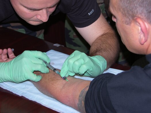 Master Sgt. Keith A. Palmer, 911th Security Forces Squadron, sets up an IV for Capt. Barry J. Strube during the Combat Lifesaver Certification portion of the Contingency Skills Training held Nov. 5 - 19, 2007. (U.S. Air Force Reserve photo/1st Sgt. Mark Dybiec)