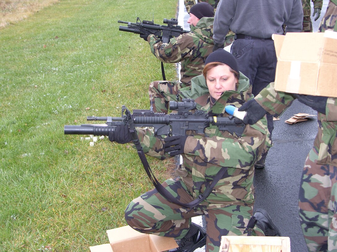 Tech. Sgt. Sonya L. Boles, 911th Security Forces, receives a 40 mm grenade to load into her M203 grenade launcher during the weapons qualification portion of the Contingency Skills Training held at Youngstown Air Reserve Station, Ohio, Nov. 5, 2007. (U.S. Air Force Reserve photo/1st Sgt. Mark Dybiec)