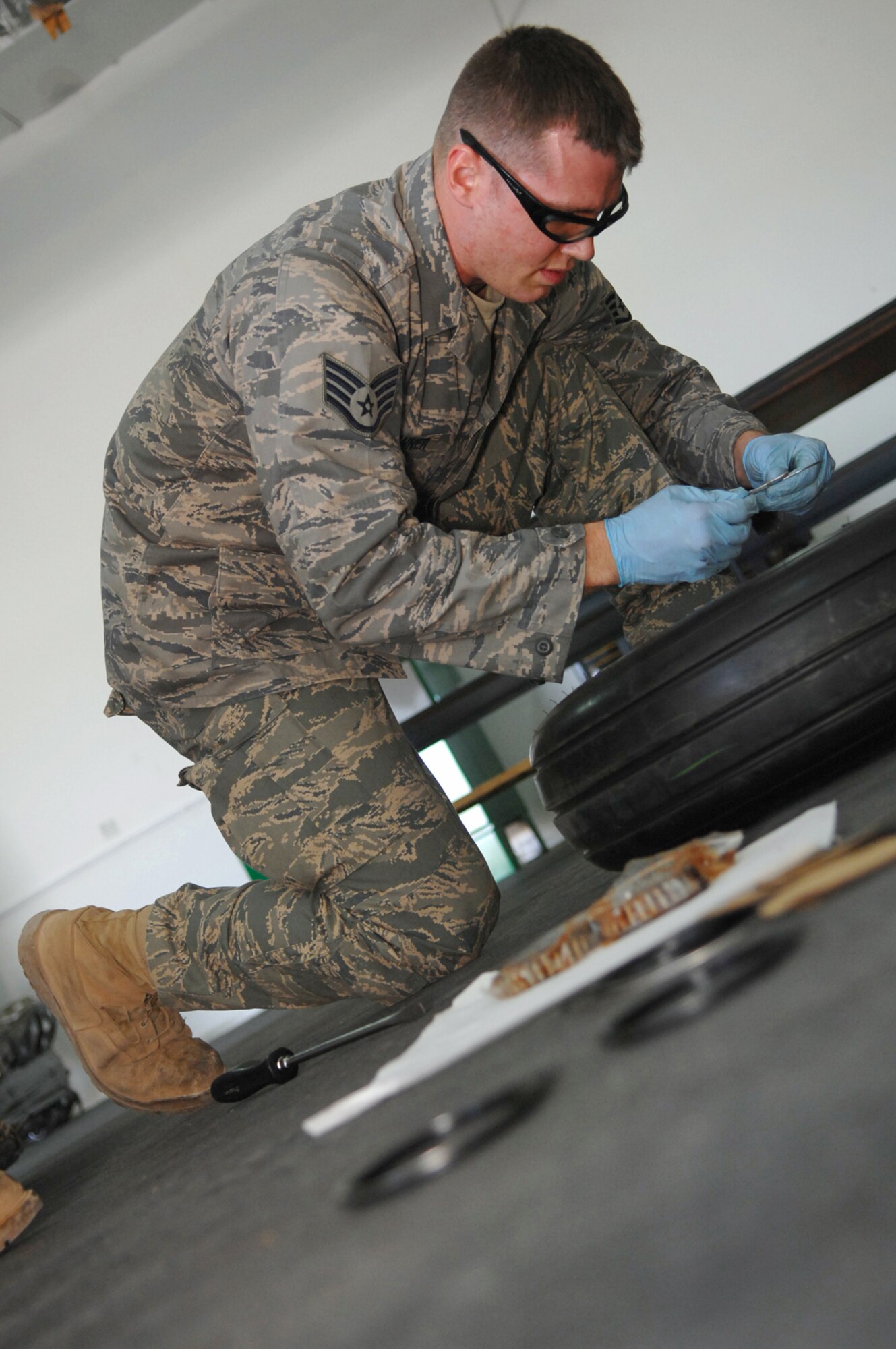 BALAD AIR BASE, Iraq -- Staff Sgt. Joshua Banner, 332nd Expeditionary Maintenance Squadron crew chief, replaces retaining rings on an F-16 Fighting Falcon's main landing gear wheel here, March 29. The 332 EMXS provides combat-ready aircraft and munitions to the air component commander in support of coalition forces throughout Iraq. Sergeant Banner is deployed from Seymour Johnson Air Force Base, N.C. (U.S. Air Force photo/ Senior Airman Julianne Showalter)