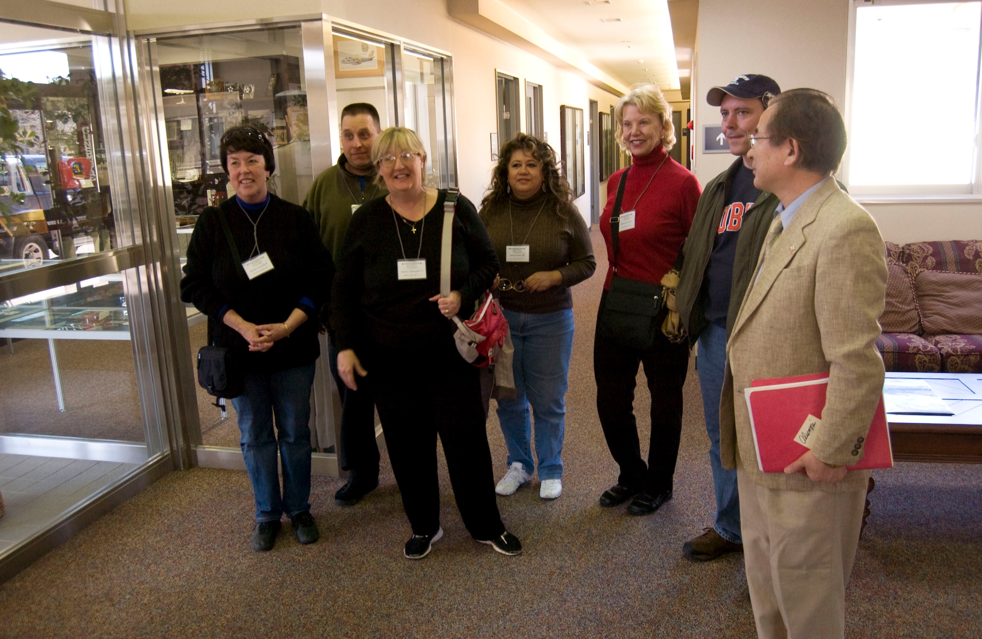MISAWA AIR BASE, Japan -- (From left to right) Melinda Chayra, William Blake, Sharon Laubenstein, Gloria Crawford, Sharon Govern, and Scott Duboraw arrive at the 35th Fighter Wing Headquarters with Hitoshi Mikami on April 2, 2008. This group consists of alumni of Edgren High School, the Department of Defense high school at Misawa Air Base. (U.S. Air Force photo by Senior Airman Samuel Morse)