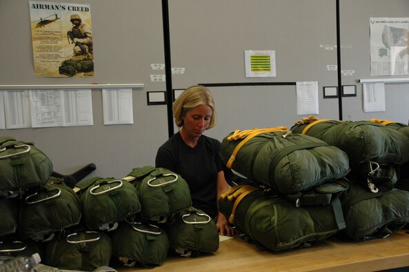 PATRICK AIR FORCE BASE, Fla. - Senior Amn Kameron Travis pulls parachutes, starting the 5 step inspection process each parachute goes through prior to a jump.