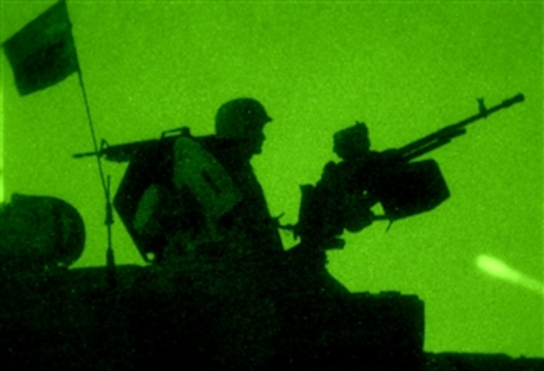 An Iraqi army soldier provides security from atop a T-72 Iraqi army tank near Camp Taji, Iraq, March 31, 2008.  The Iraqi soldiers are assigned to 2nd Tank Battalion, 34th Armor Brigade, 9th Iraqi Army Division (Mechanized).