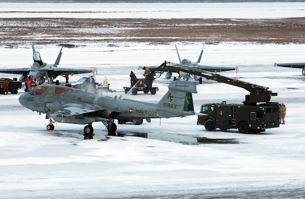 Maintainers remove snow and de-ice an EA-6B Prowler for the first official day of Red Flag-Alaska 08-2 April 7 at Eielson Air Force Base, Alaska. Red Flag-Alaska provides training for deployed maintenance and support personnel in sustainment of a large-force deployed air operation. He is assigned to the Royal Australian Air Force. The Prowler is assigned to the Naval Air Station Widbey Island. (U.S. Air Force Photo/Airman 1st Class Jonathan Snyder)