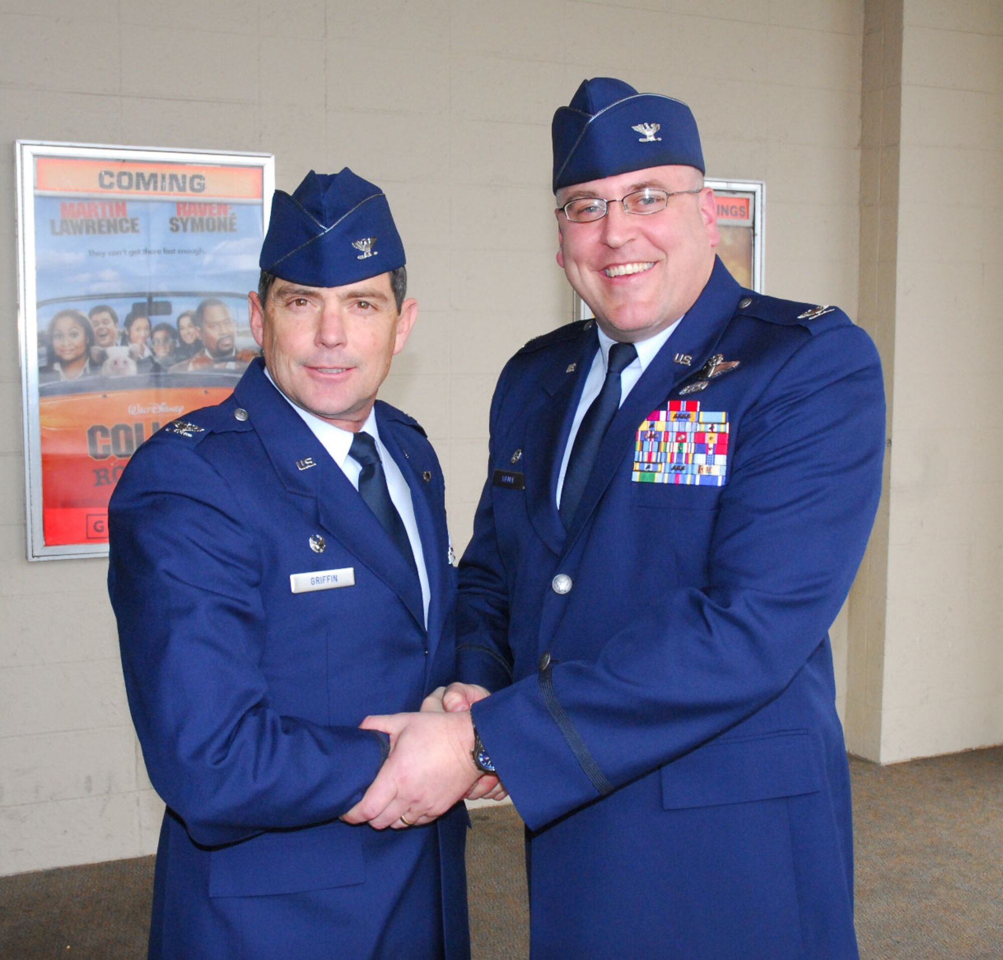 Col. John O. Griffin shakes hands with Col. Donald ?Scott? Wenke following a change of command ceremony April 5 at the base theater in which Wenke took command of the 168th Air Refueling Wing at Eielson Air Force Base. (U.S. Air Force photo by Capt. Guy Hayes, DMVA Public Affairs)