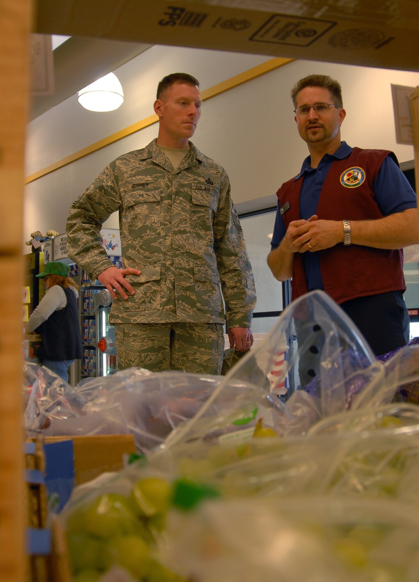 Andrew Brooks, Edwards Commissary store director, talks with Chief Master Sgt. William Gurney, Air Force Materiel Command command chief, as they walk through the produce aisle of the Commissary here April 4. Chief Gurney received a tour of the Base Exchange and Commissary before being the guest speaker at the Team Edwards Chief Master Sergeant Recognition Ceremony that evening. (Air Force photo by Senior Airman Stacy Sanchez)