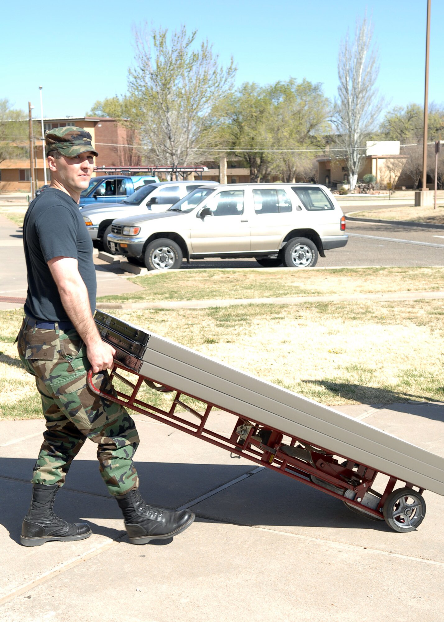 CANNON AIR FORCE BASE, N.M. - - Staff Sgt. Christopher Moody, 27th Special Operations Mission Support Squadron, pulls a dolly carrying new furniture to the Military Personel Flight office on April 7. 27th SOMSS Airmen spent the better part of the morning moving furniture into their office, which is being renovated. (U.S. Air Force photo by Airman Basic Danielle Martin)