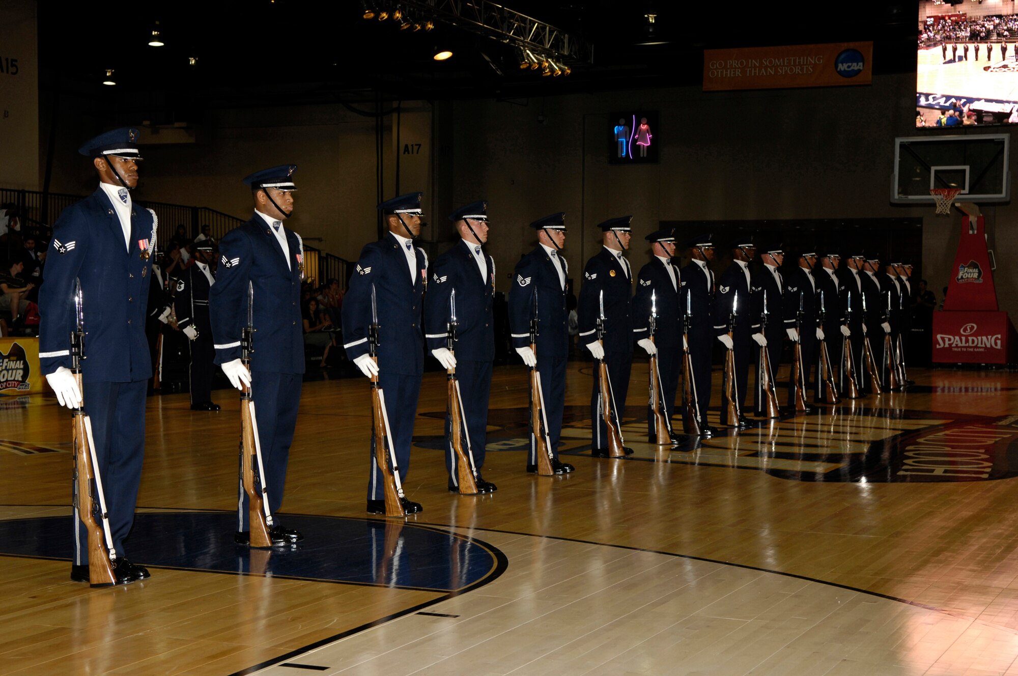 The Air Force Honor Guard Drill Team performs at the NCAA Men's Final Four events at the Hoop City Center Court. The Drill Team is the travelling component of the Air Force Honor Guard and tours worldwide showcasing the precision of today's Air Force, to recruit, retain and inspire Airmen for the Air Force mission. (U.S. Air Force photo by SSgt Raymond Mills)