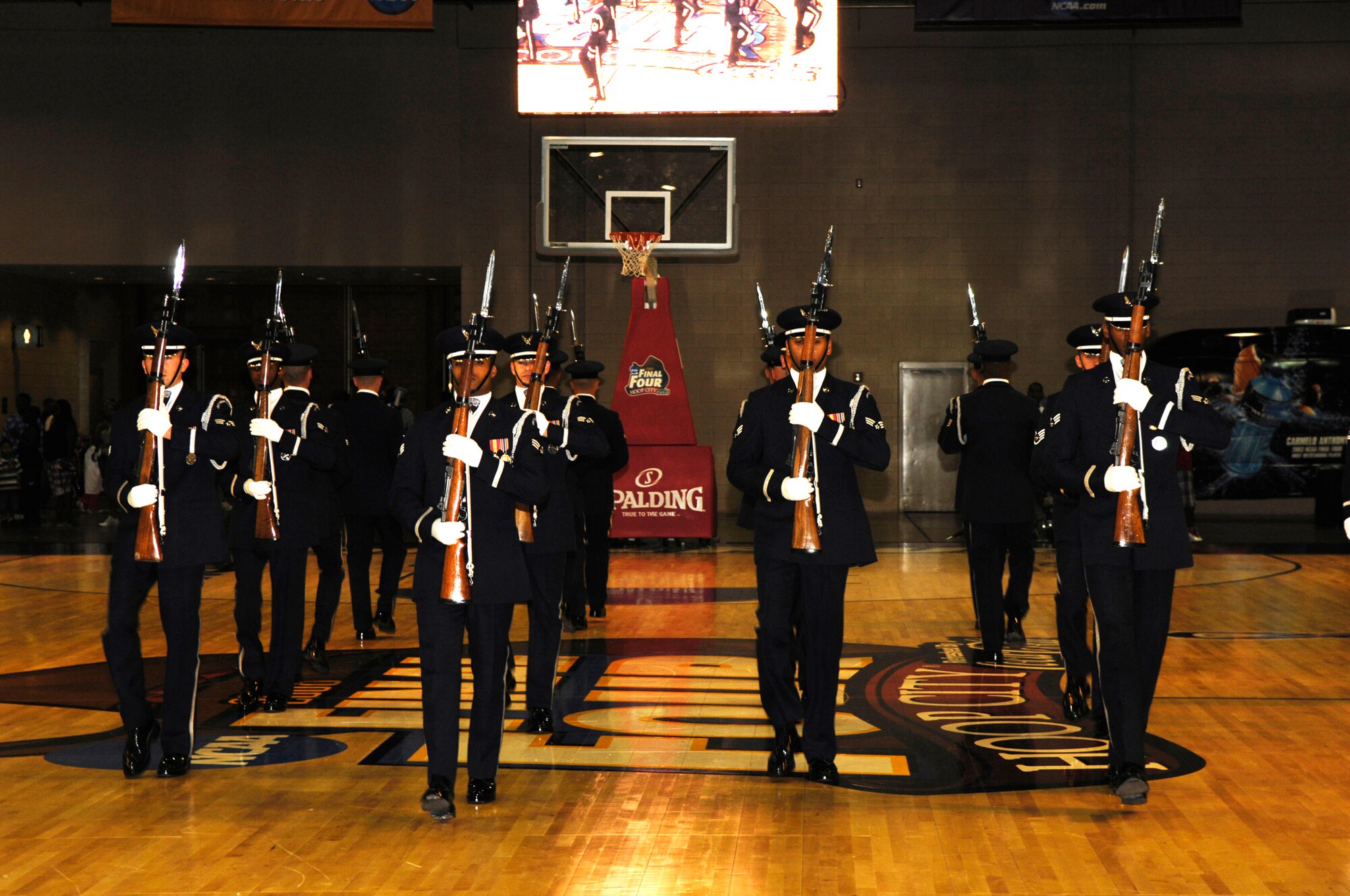 The USAF Honor Guard Drill Team enters Center Court at Hoop City during their performance before the 2008 NCAA Men's Final Four. The Drill Team is the travelling component of the Air Force Honor Guard and tours worldwide showcasing the precision of today's Air Force, to recruit, retain and inspire Airmen for the Air Force mission. (U.S. Air Force photo by SSgt Raymond Mills)