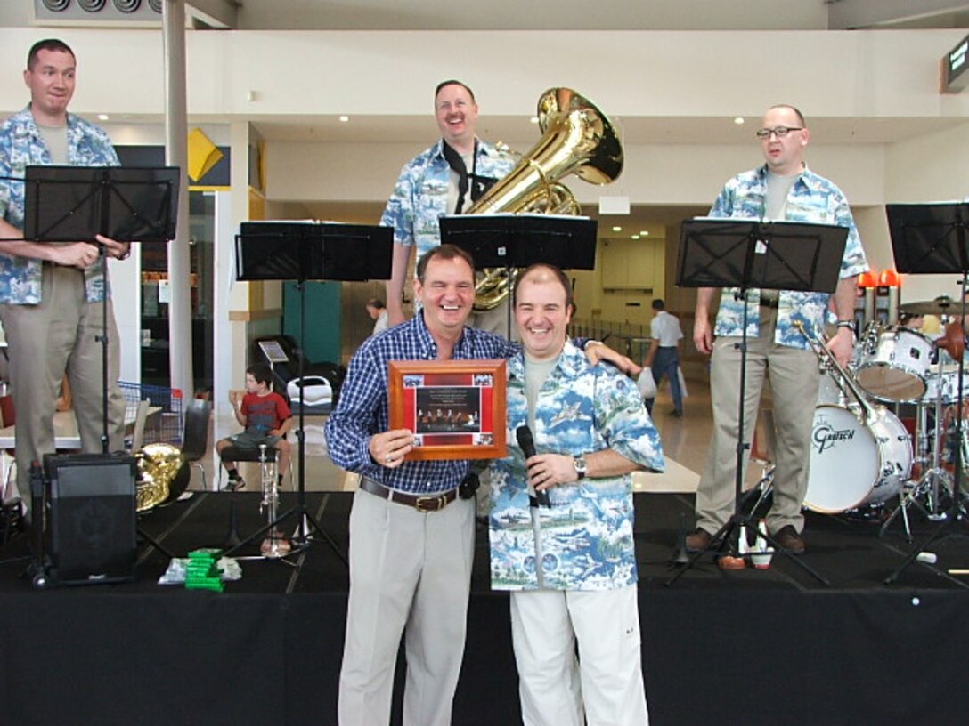 Major Matthew Henry, Commander, USAF Band of the Pacific, presents a plaque from the Alaska Brass to Mayor Paul Pisasle, Ipswich, Australia.
