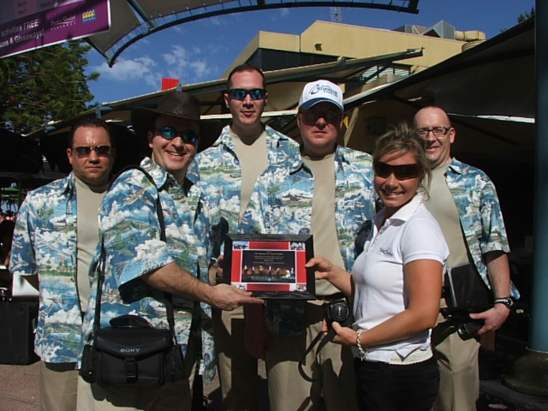 Major Henry, Commander, USAF Band of the Pacific, presents a plaque from Alaska Brass to Elise Johnston, Cavill Mall, on the Gold Coast, Brisbane, Australia.
