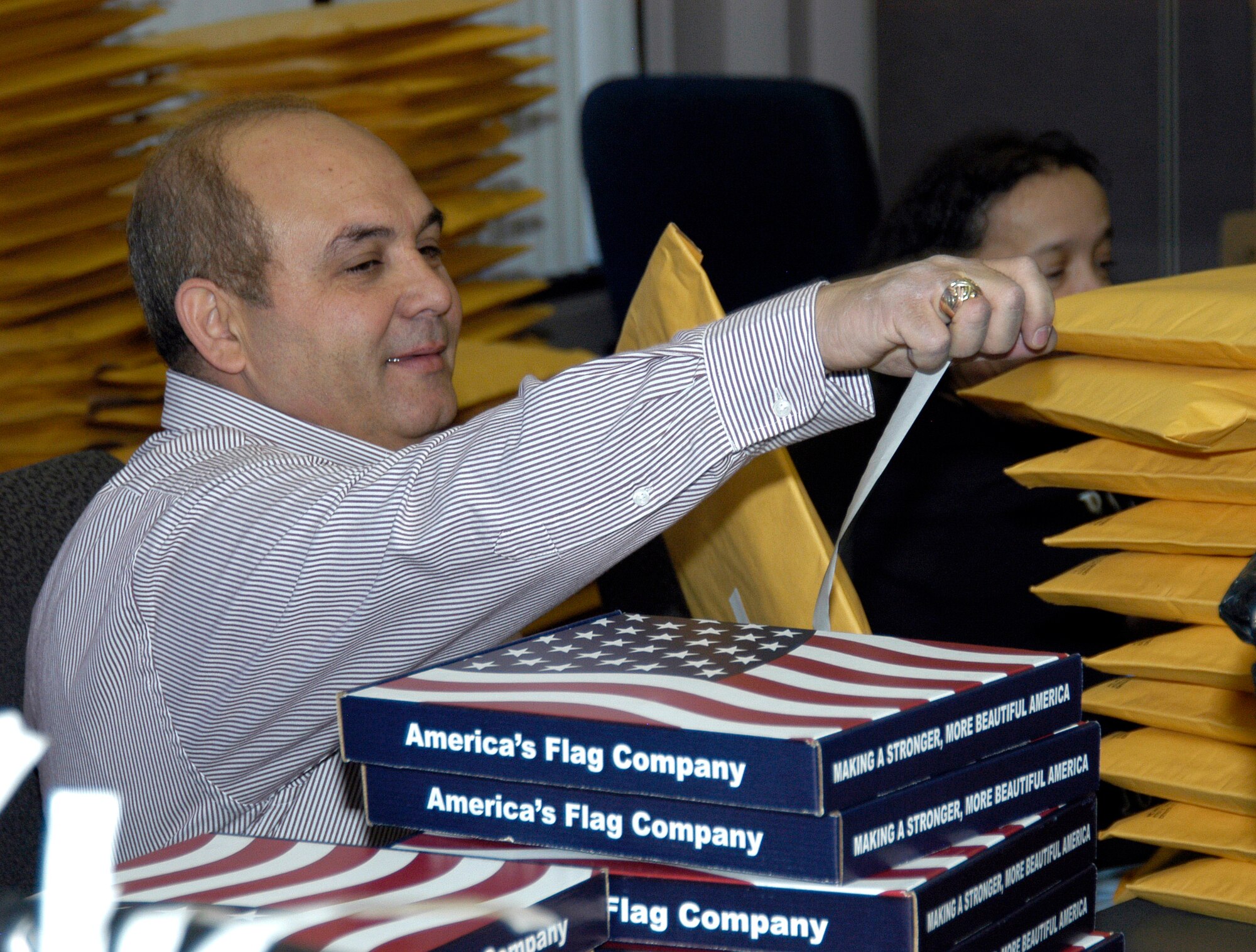 Waleed Sharbini prepares to mail a U.S. flag April 4 at the Air Reserve Personnel Center in Denver. Flags are sent to retiring reservists who request one through ARPC's online retirement application. (U.S. Air Force photo/Mike Molina) 
