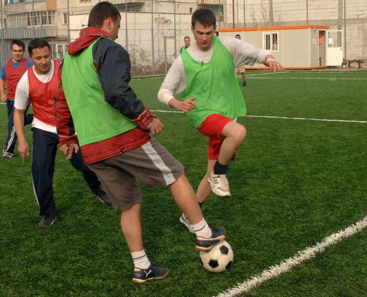 American Airmen members play soccer with Romanian airmen March 29 at Campia Turzii, Romania. The Airmen are deployed as part of the U.S. military's support to the NATO summit. U.S. Airmen augmented NATO and Romanian forces, ensuring the security of the airspace above Bucharest. (U.S. Air Force photo/Senior Airman Teresa M. Hawkins) 
