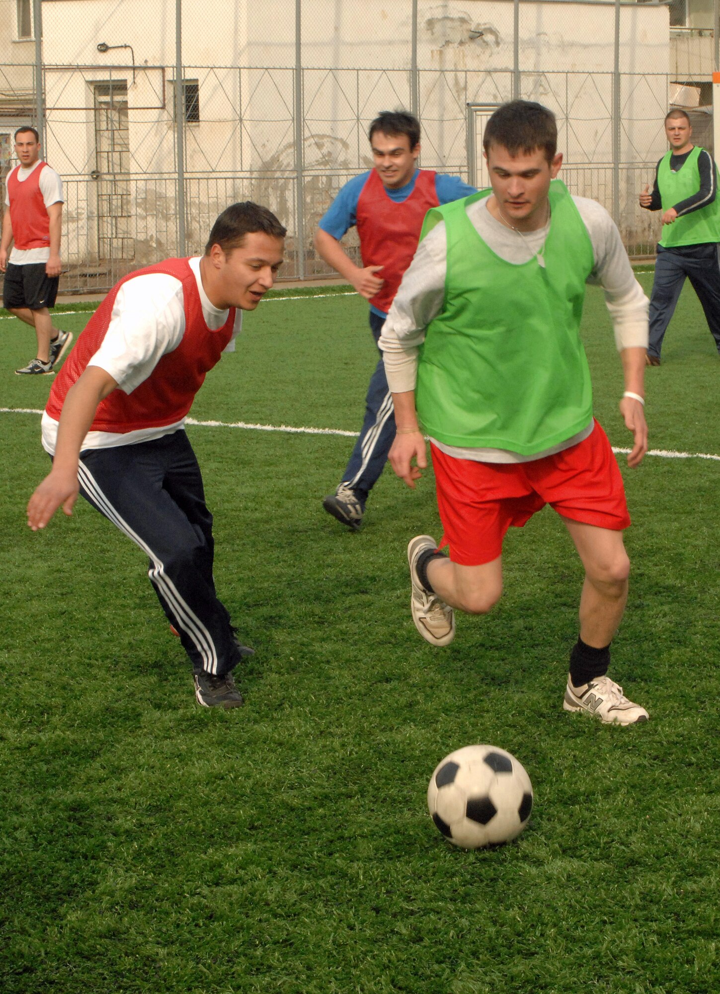 American Airmen members play soccer with Romanian airmen March 29 at Campia Turzii, Romania. The Airmen are deployed as part of the U.S. military's support to the NATO summit. U.S. Airmen augmented NATO and Romanian forces, ensuring the security of the airspace above Bucharest. (U.S. Air Force photo/Senior Airman Teresa M. Hawkins) 
