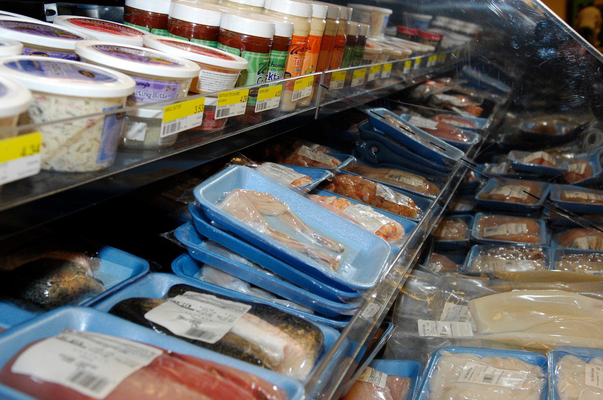 MINOT AIR FORCE BASE, N.D. – The fresh fish counter opened here April 2 showing the large variety of fish and seafood available to commissary consumers.  Among the many choices are walleye, salmon and frog legs. If the customer sees an item on the product list that is not currently in the store, they can order by Wednesday and receive the order the following Wednesday. (U.S. Air Force photo by Staff Sgt. Thomas Dow)