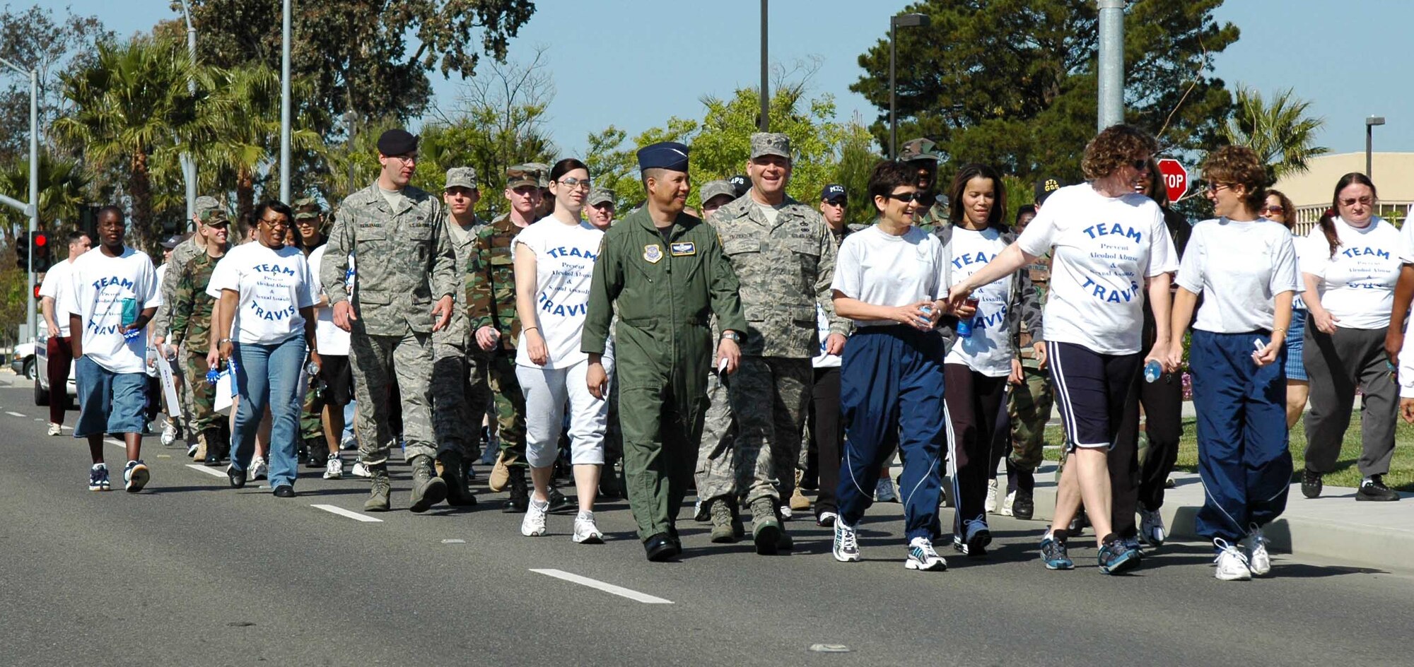Team Travis members participate in the Sexual Assault Awareness Month Walk ,  April 3. Beginning at the base theater, walkers made a stop at wing headquarters where Col. GI Tuck, 60th Air Mobility Wing vice commander, signed the SAAM Proclamation. The walk was an opportunity  to raise awareness about sexual assault. (U.S. Air Force photo/Tech. Sgt. Donald Osborn)