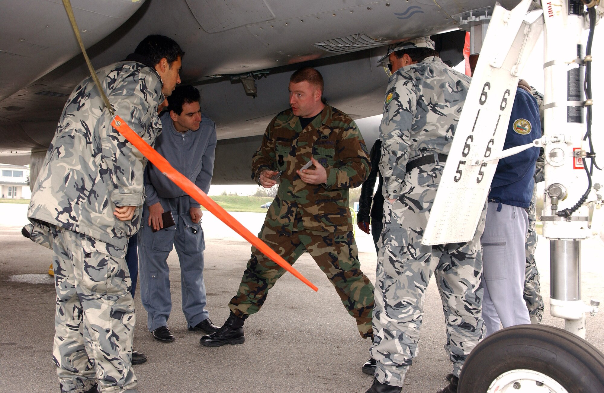 Staff Sgt. Robert Jackson explains the process of purchasing fuel in a NATO country in order to refuel an F-15 Eagle to a group of Bulgarian air force crew chiefs April 2 at Graf Ignatievo Air Base, Bulgaria. Sergeant Jackson is an F-15 crew chief participating in a familiarization program while deployed for Operation Noble Endeavor. (U.S. Air Force photo/Tech. Sgt. Jill LaVoie) 
