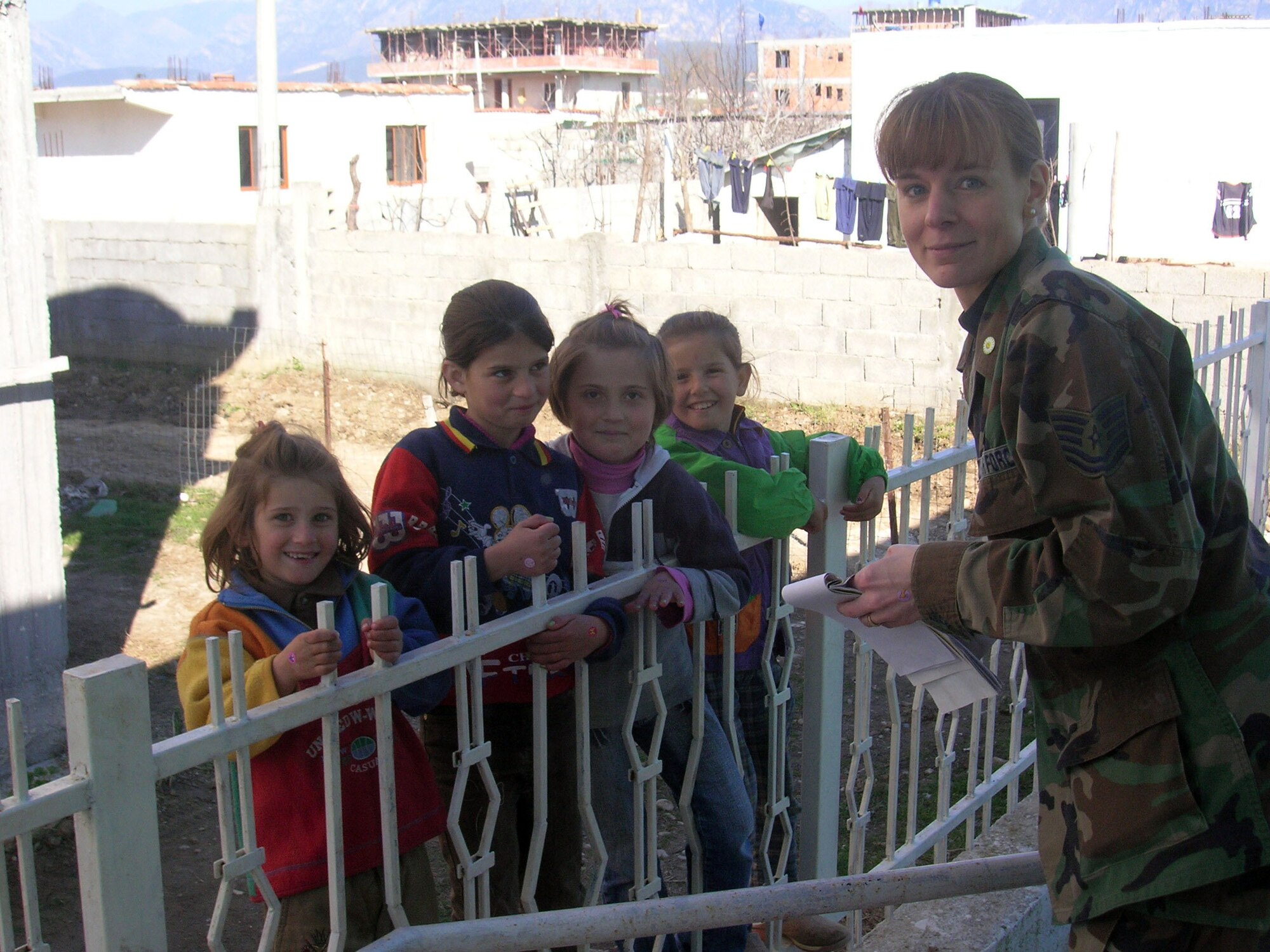 Tech. Sgt. Jacqueline Sweet-McNeil visits with children in February in Albania. Sergeant Sweet-McNeil, along with four other 109th Airlift Wing medics from the Stratton Air National Guard Base in New York, administered 1,000 Hepatitis A shots during a humanitarian mission with the New Jersey National Guard. (Courtesy photo)
