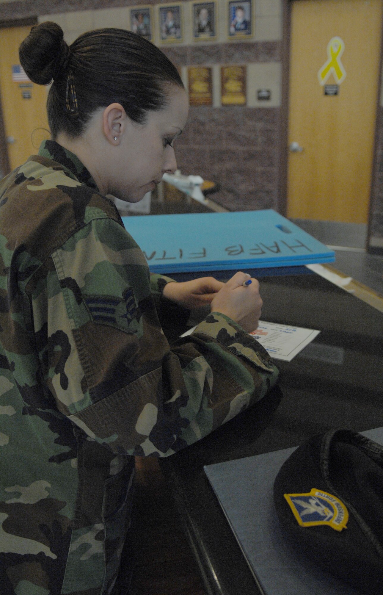 A 49th Securtiy Forces Squadron, physical training leader (PTL) signs out mats and a caluator for the evaluation of Security forces members April 4, at Holloman Air Force Base, N.M..The variables used in the calculation are age, gender, abdominal circumference, number of push-ups completed, number of sit-ups completed, and time/score on an aerobic assessment. 
(U.S. Air Force photo/ Senior Airman Anthony Nelson Jr)